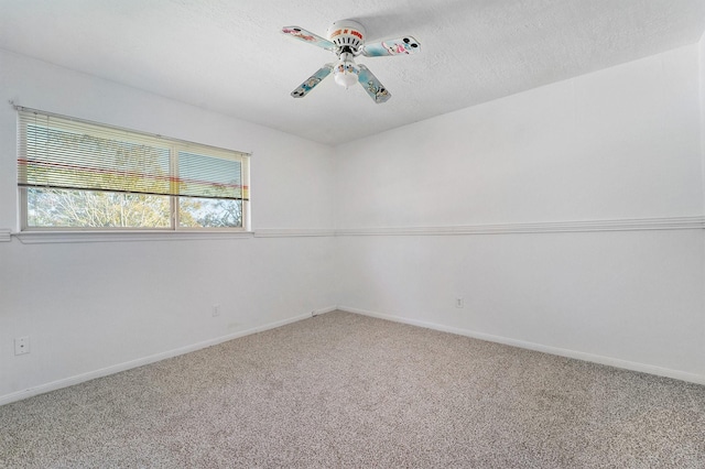 carpeted spare room featuring ceiling fan and a textured ceiling