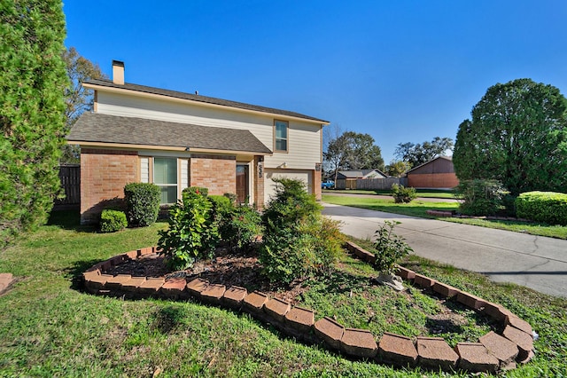 view of front of property with a front lawn and a garage