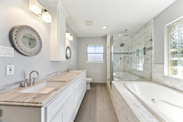 full bathroom with vanity, toilet, wood-type flooring, and independent shower and bath