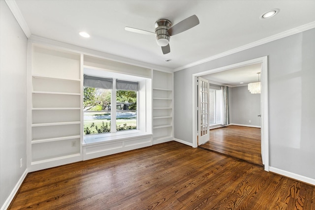 unfurnished room featuring ornamental molding, built in features, ceiling fan, and dark wood-type flooring