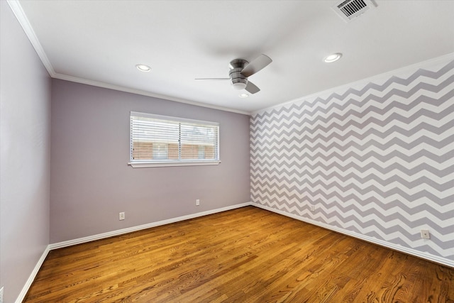 empty room with wood-type flooring, ceiling fan, and ornamental molding