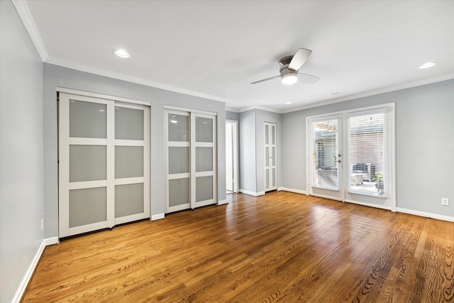 interior space featuring french doors, light hardwood / wood-style floors, ceiling fan, and crown molding