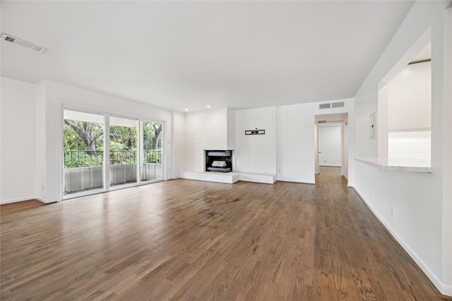 unfurnished living room with wood-type flooring and a fireplace