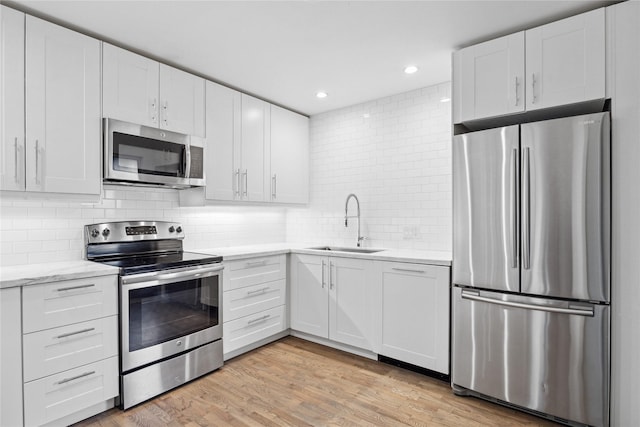 kitchen with white cabinets and appliances with stainless steel finishes