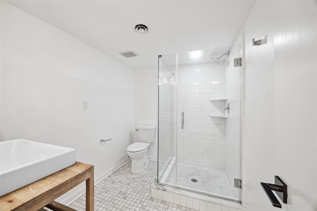 bathroom featuring toilet, tile patterned flooring, and walk in shower