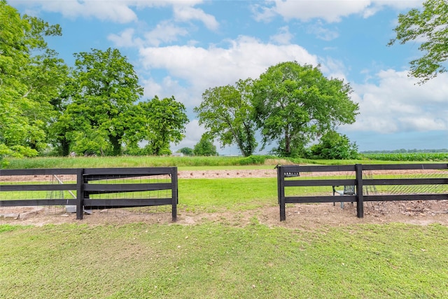 view of gate featuring a yard and a rural view