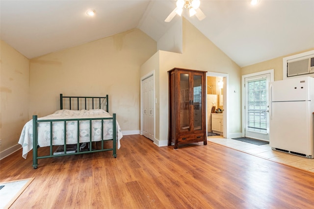 bedroom with connected bathroom, ceiling fan, high vaulted ceiling, white fridge, and light wood-type flooring