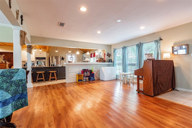 living room with ceiling fan and light hardwood / wood-style flooring