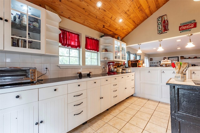 kitchen with tasteful backsplash, white cabinets, pendant lighting, and wood ceiling