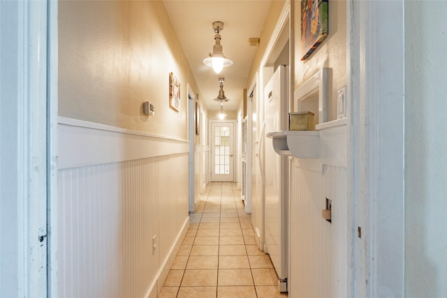 hall with light tile patterned floors