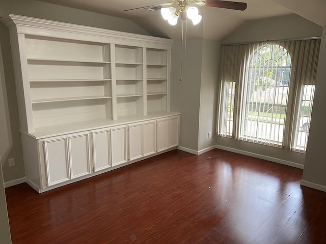 empty room featuring dark hardwood / wood-style flooring, ceiling fan, plenty of natural light, and lofted ceiling