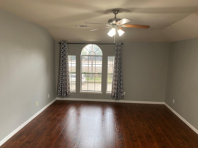 empty room with ceiling fan, dark wood-type flooring, and vaulted ceiling