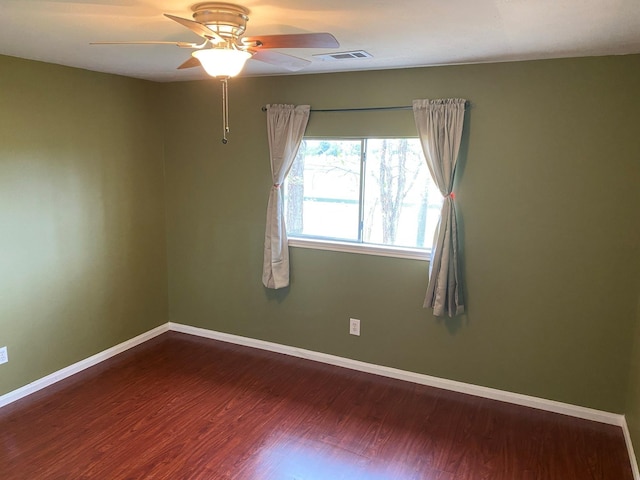 empty room featuring hardwood / wood-style floors and ceiling fan