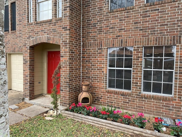 view of exterior entry with a garage