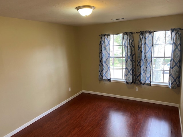 unfurnished room featuring dark hardwood / wood-style flooring