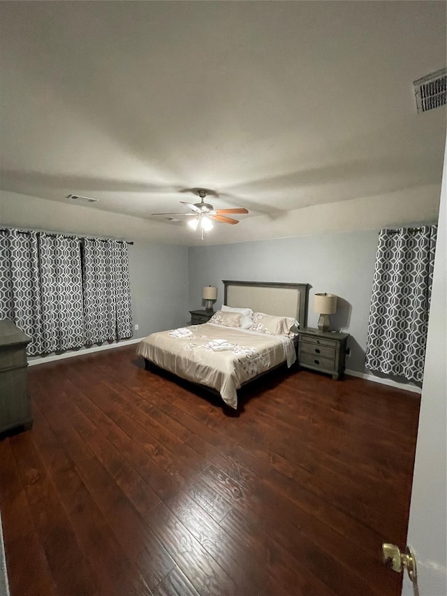 unfurnished bedroom featuring ceiling fan and dark hardwood / wood-style floors