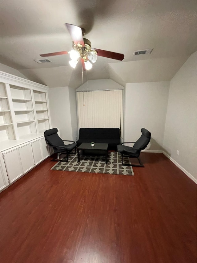 living area with dark hardwood / wood-style floors, vaulted ceiling, and ceiling fan