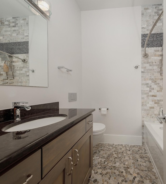 full bathroom featuring toilet, vanity, and bathing tub / shower combination