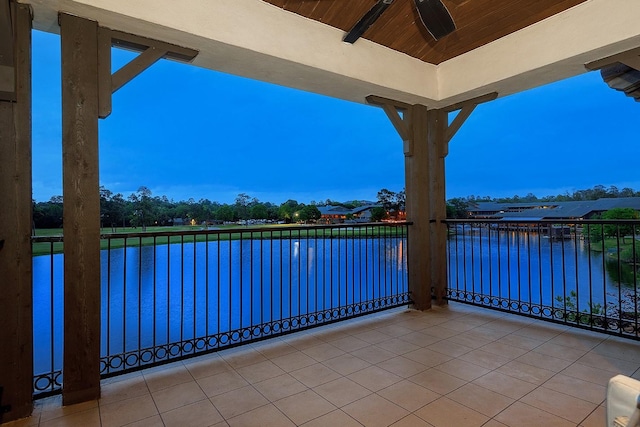 view of patio / terrace featuring ceiling fan, a water view, and a balcony