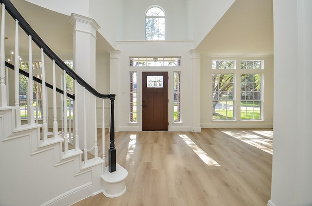 entryway featuring light hardwood / wood-style flooring and a high ceiling