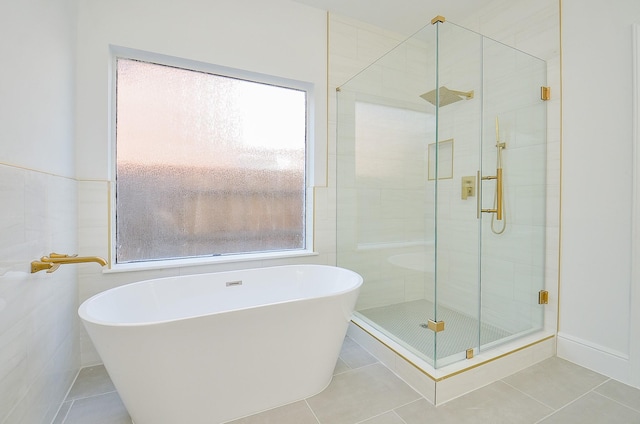 bathroom featuring tile patterned floors and separate shower and tub