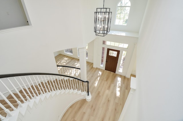 foyer entrance featuring hardwood / wood-style flooring and a notable chandelier