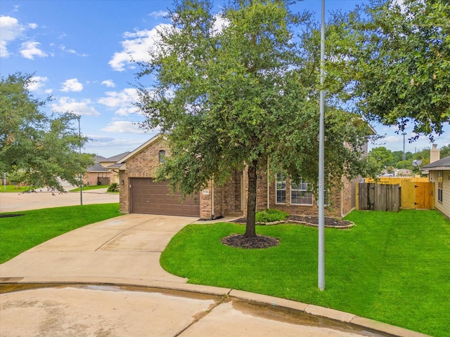 view of property hidden behind natural elements featuring a garage and a front lawn