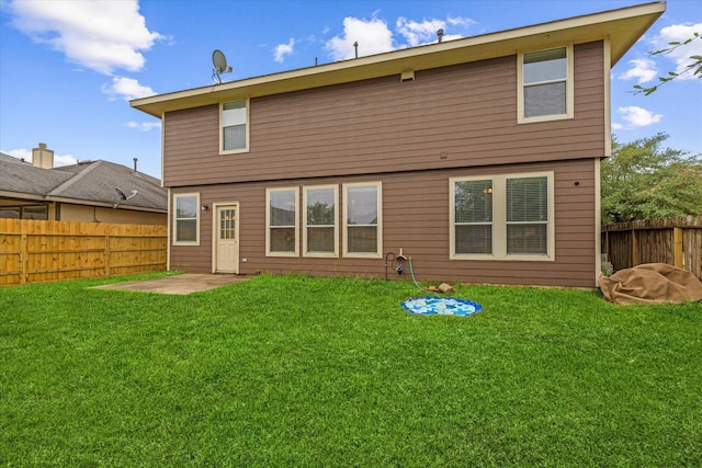 rear view of house with a patio area and a yard