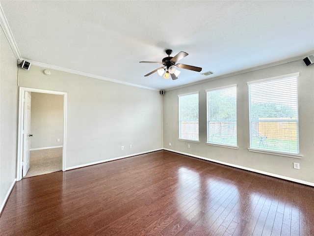 unfurnished room with a textured ceiling, dark hardwood / wood-style floors, ceiling fan, and ornamental molding