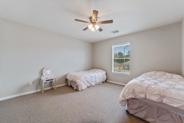 bedroom featuring ceiling fan and carpet