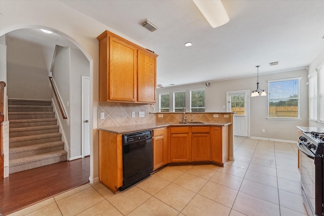 kitchen with backsplash, black dishwasher, a wealth of natural light, range with gas stovetop, and light tile patterned flooring