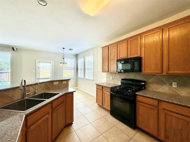 kitchen with black appliances, sink, hanging light fixtures, light tile patterned floors, and tasteful backsplash