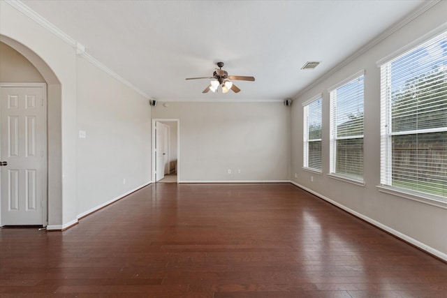 unfurnished room featuring ceiling fan, crown molding, and dark wood-type flooring