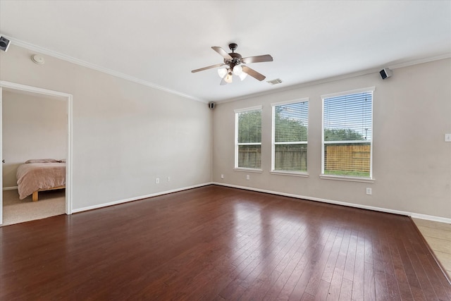 empty room with ceiling fan, dark hardwood / wood-style floors, and ornamental molding