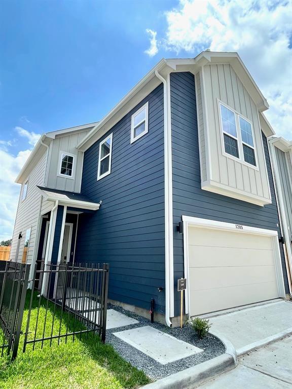 view of home's exterior with a garage and a yard