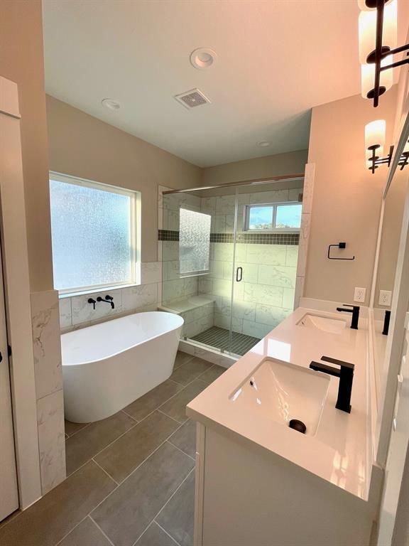 bathroom with tile patterned flooring, vanity, and shower with separate bathtub