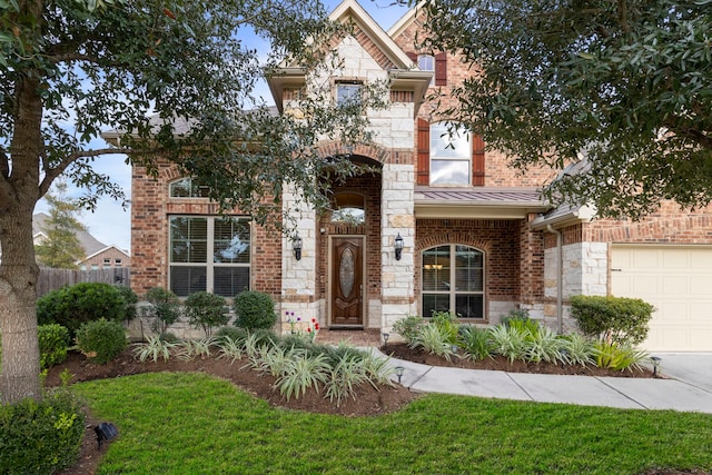 view of front of property featuring a front yard and a garage