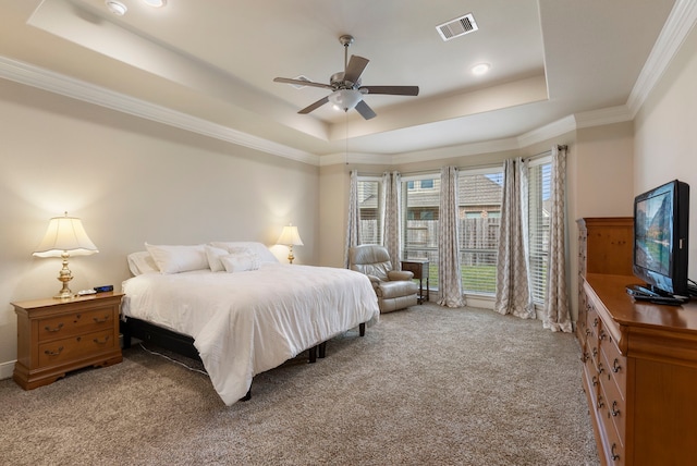 bedroom with ceiling fan, a raised ceiling, ornamental molding, and light carpet