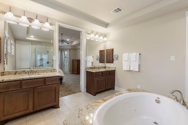 bathroom featuring vanity, tile patterned floors, ceiling fan, a tray ceiling, and tiled bath