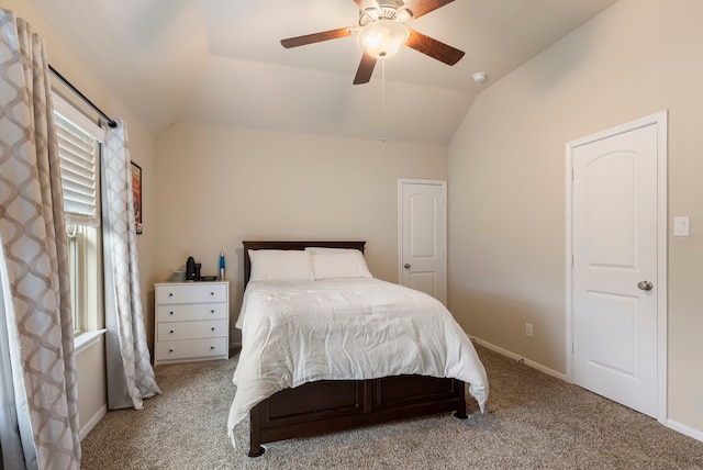 bedroom featuring ceiling fan, light carpet, and vaulted ceiling