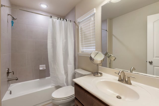 full bathroom featuring shower / tub combo, vanity, and toilet