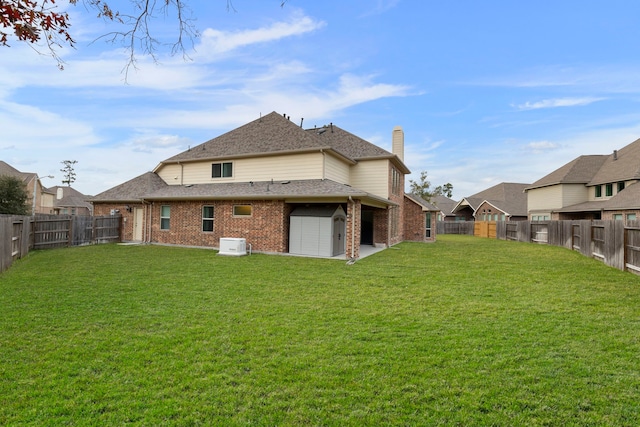 rear view of property featuring a lawn