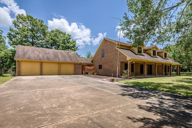 view of front of property with a front lawn and a garage