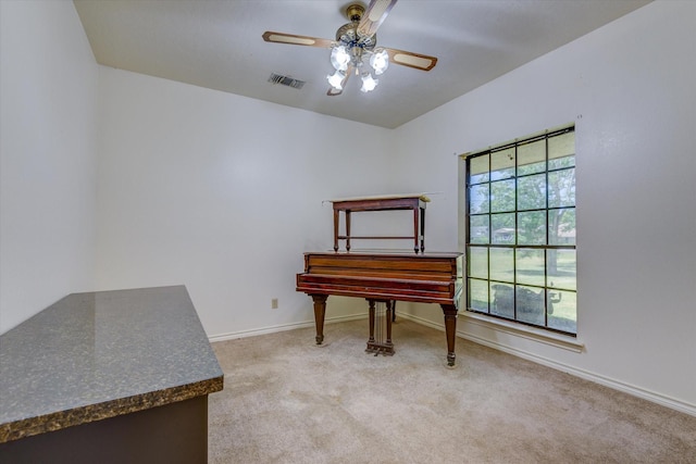 misc room with ceiling fan and light colored carpet