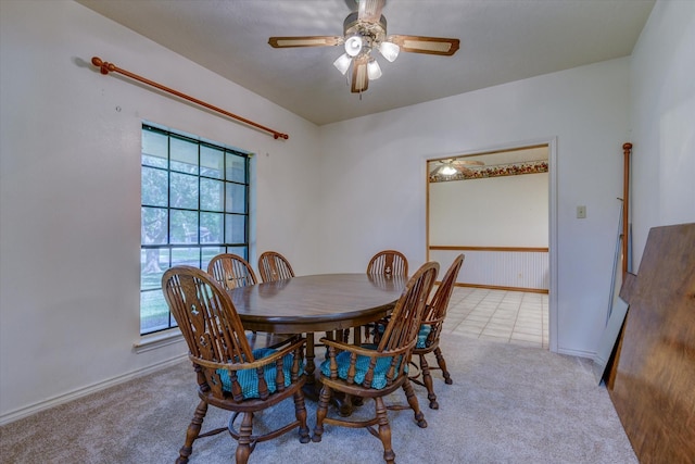 dining room with ceiling fan and light colored carpet