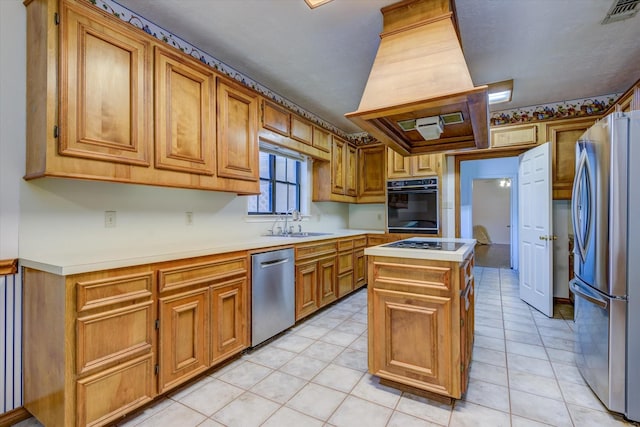 kitchen with a center island, sink, stainless steel appliances, and light tile patterned flooring