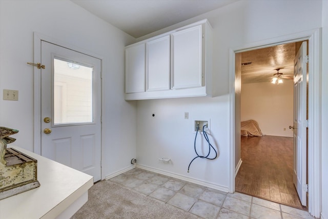 clothes washing area featuring electric dryer hookup, cabinets, hookup for a washing machine, ceiling fan, and light tile patterned flooring