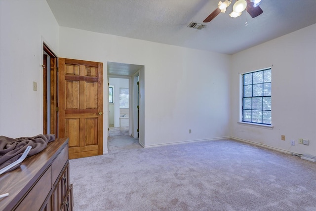 unfurnished bedroom featuring ceiling fan and light colored carpet