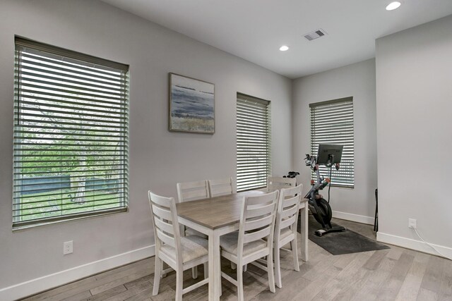 dining space with light hardwood / wood-style flooring