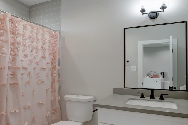 bathroom featuring vanity, toilet, and curtained shower